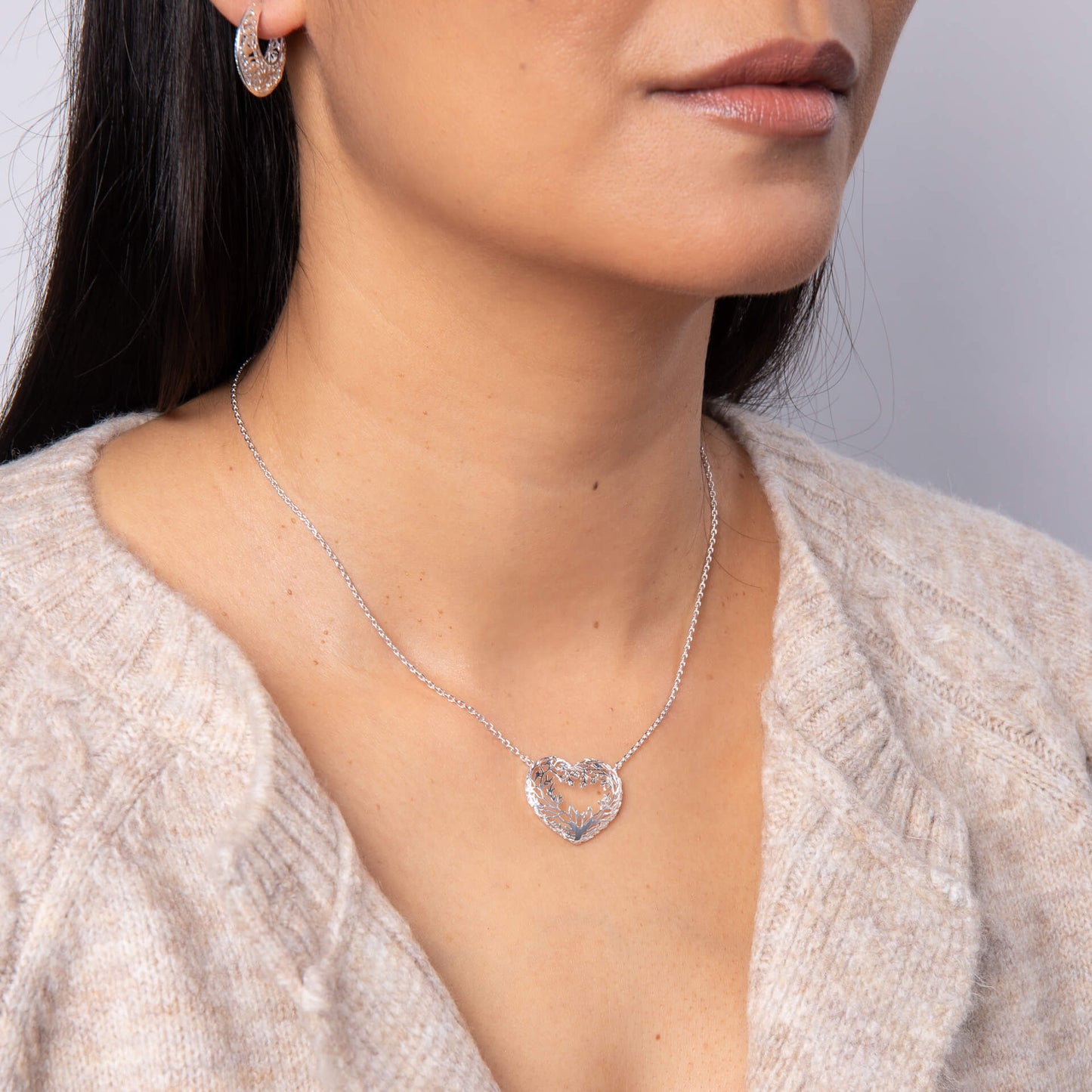 A woman wearing the Laura Ashley Firbeck Toile Heart Necklace.