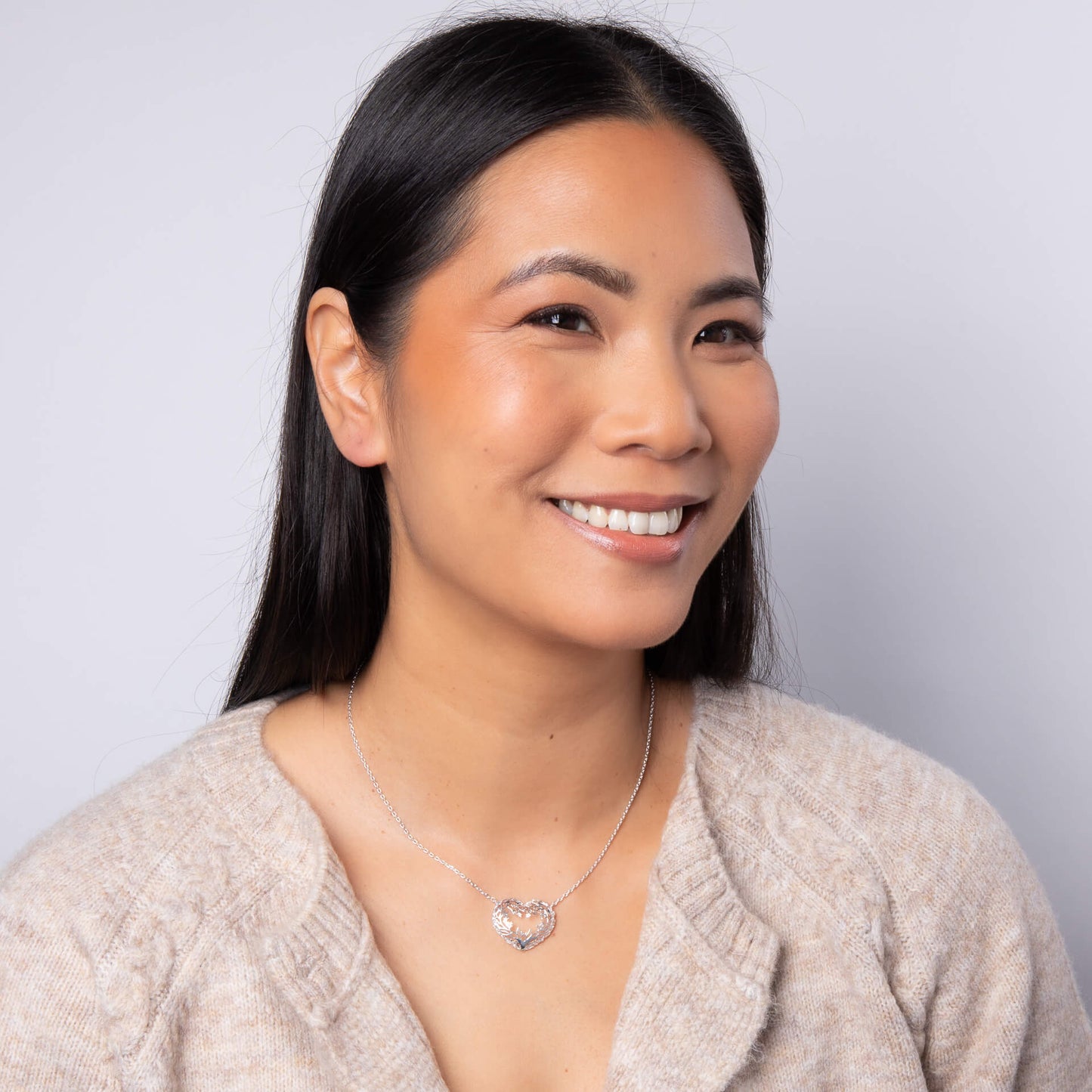 A woman wearing the Laura Ashley Firbeck Toile Heart Necklace.