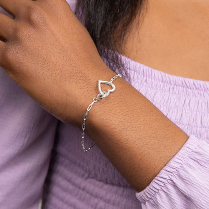 A woman wearing the Beginnings Heart Connection Chain Bracelet.
