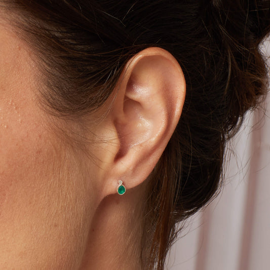 A woman wearing the Laura Ashley Thornage Flowers stud earrings.