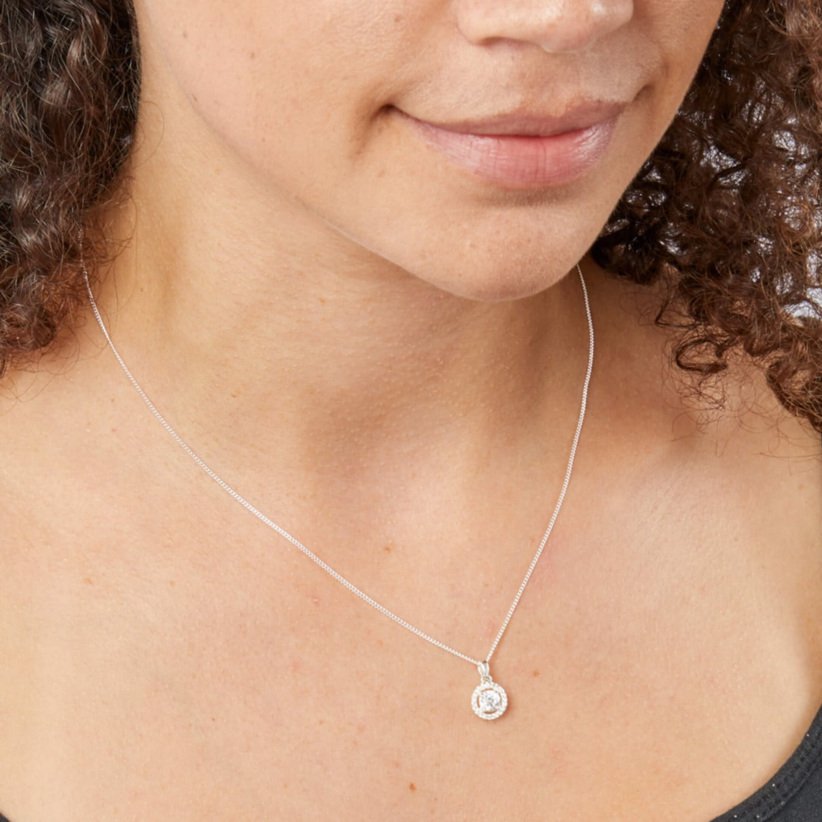 A woman wearing the Beginnings pavé-set cluster pendant.