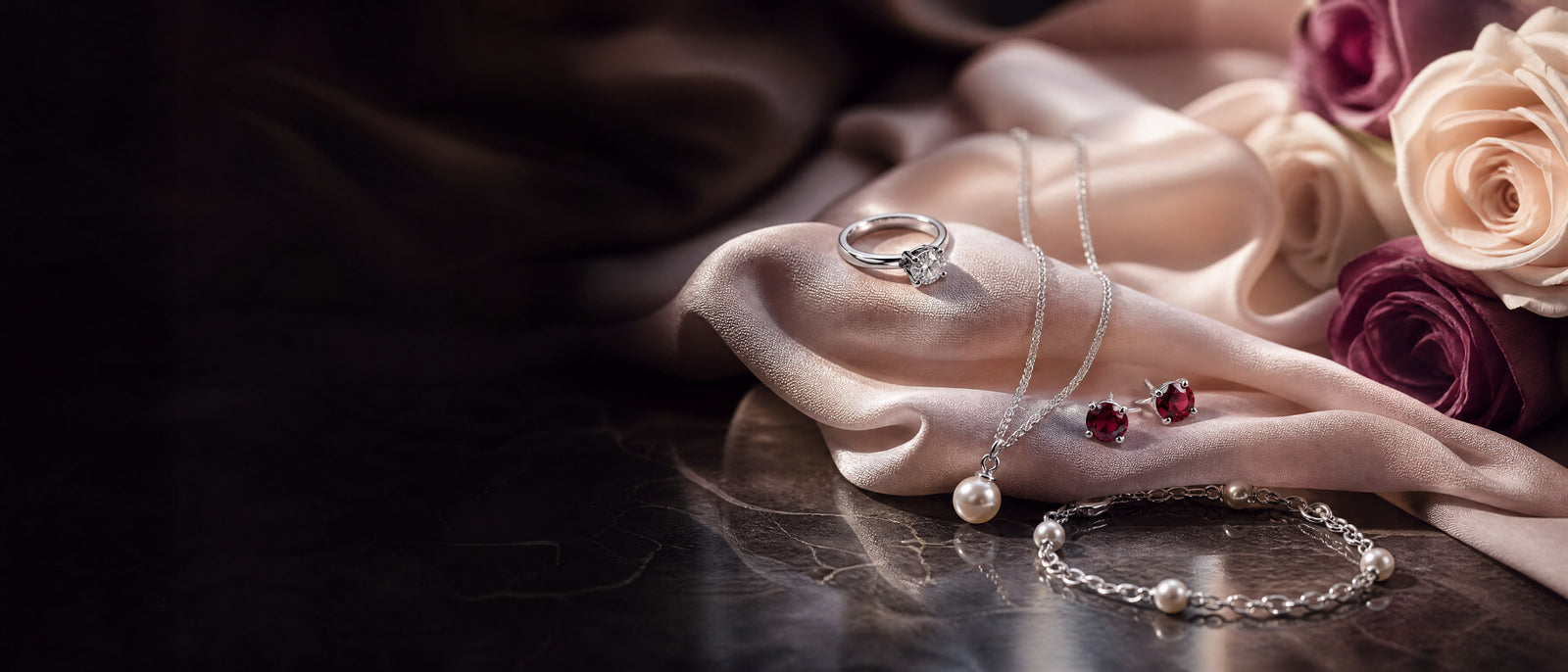A woman in soft evening light wearing a fine silver necklace and drop earrings